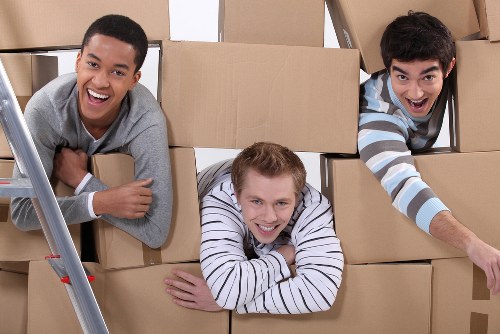 Removal team preparing a move in Roehampton with boxes and furniture