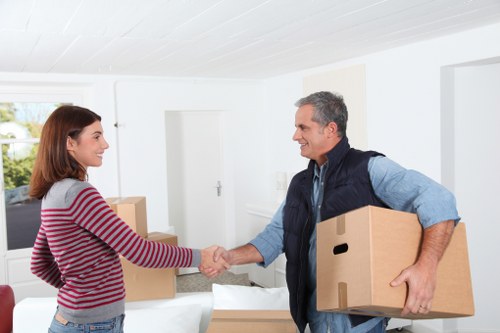 Professional movers organizing boxes and fragile items in Roehampton